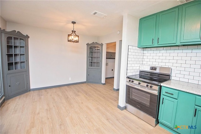 kitchen featuring backsplash, hanging light fixtures, stainless steel stove, green cabinetry, and light wood-type flooring