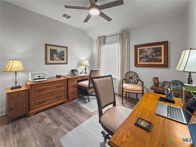 office area featuring lofted ceiling, wood finished floors, visible vents, and a ceiling fan