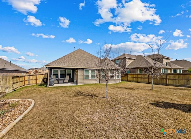 back of property featuring a yard, a fenced backyard, and a patio