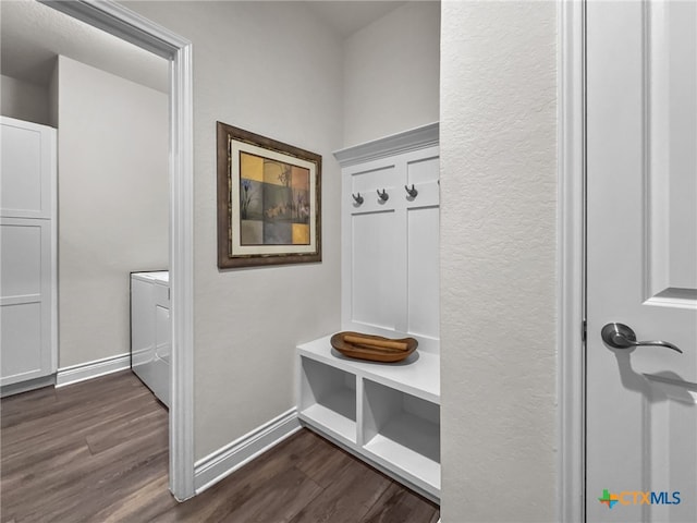 mudroom with dark wood finished floors and baseboards