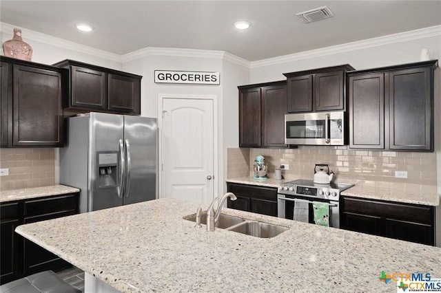 kitchen with sink, dark brown cabinets, ornamental molding, and appliances with stainless steel finishes