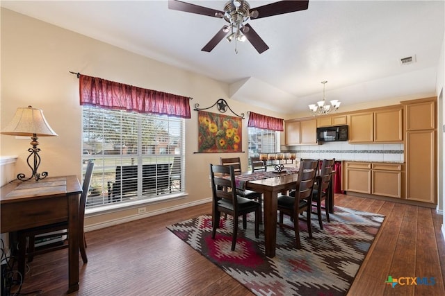 dining room featuring visible vents, ceiling fan with notable chandelier, baseboards, and dark wood-style flooring