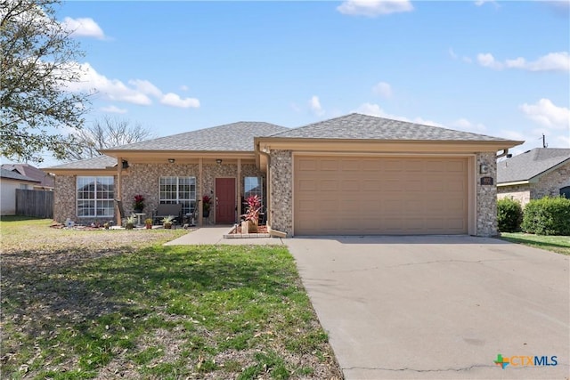 ranch-style home with an attached garage, driveway, and a front yard