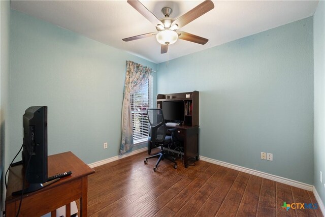 home office featuring a ceiling fan, baseboards, and wood finished floors