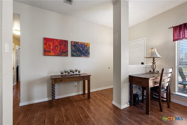 home office with visible vents, baseboards, and wood finished floors