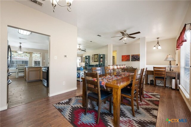 dining area with a wealth of natural light, visible vents, and wood finished floors