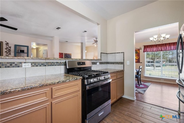 kitchen with visible vents, backsplash, dark wood finished floors, ceiling fan with notable chandelier, and stainless steel appliances