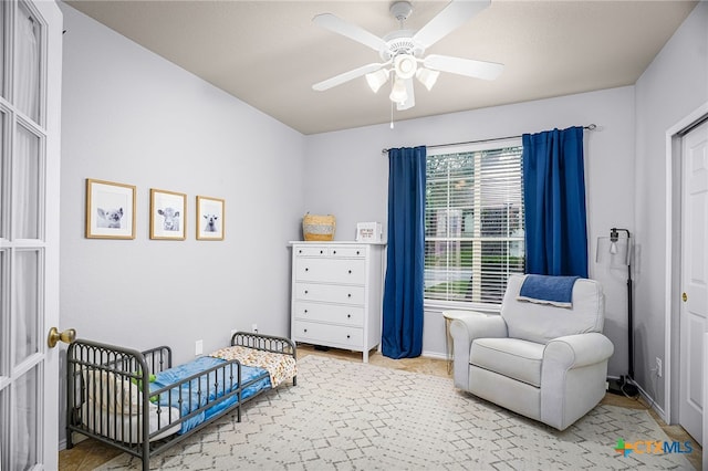 bedroom featuring baseboards and ceiling fan