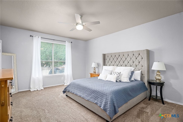 bedroom with ceiling fan, carpet flooring, and baseboards