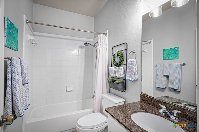 full bathroom with vanity, toilet, a textured wall, and shower / bath combination with curtain