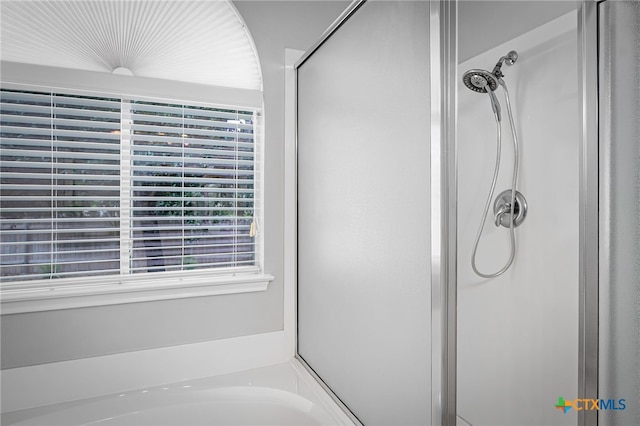 full bath featuring a shower stall and a bath