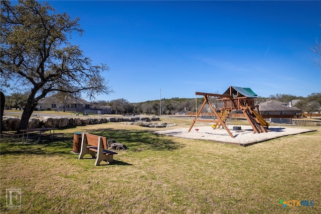 community jungle gym featuring a lawn