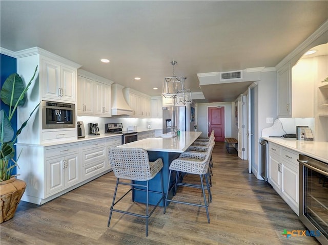 6021 State Highway 361 Unit 109, Port Aransas, TX 78373 - kitchen featuring appliances with stainless steel finishes, custom range hood, a sink, wine cooler, and white cabinets