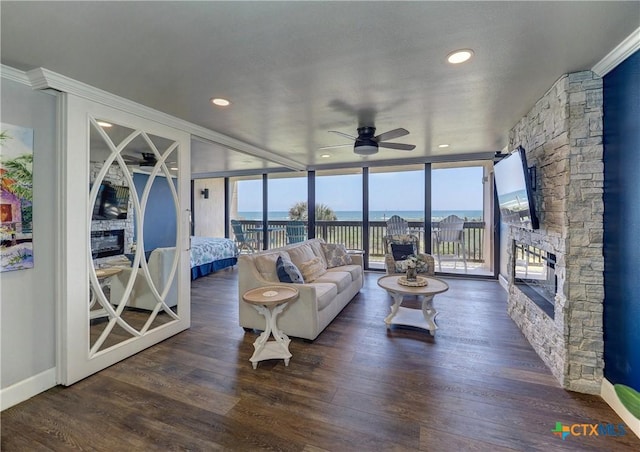 6021 State Highway 361 Unit 109, Port Aransas, TX 78373 - living room with a stone fireplace, a ceiling fan, ornamental molding, recessed lighting, and wood finished floors