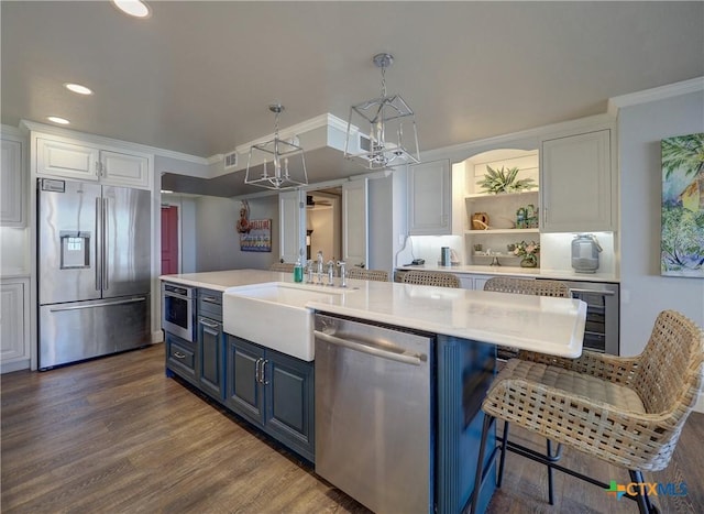 6021 State Highway 361 Unit 109, Port Aransas, TX 78373 - kitchen with stainless steel appliances, a chandelier, blue cabinetry, a sink, and white cabinets