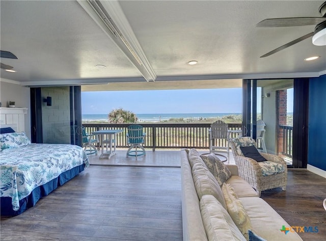 6021 State Highway 361 Unit 109, Port Aransas, TX 78373 - bedroom with access to outside, a wall of windows, wood finished floors, a water view, and recessed lighting