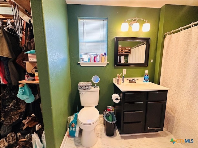 bathroom featuring tile patterned flooring, a shower with curtain, vanity, and toilet