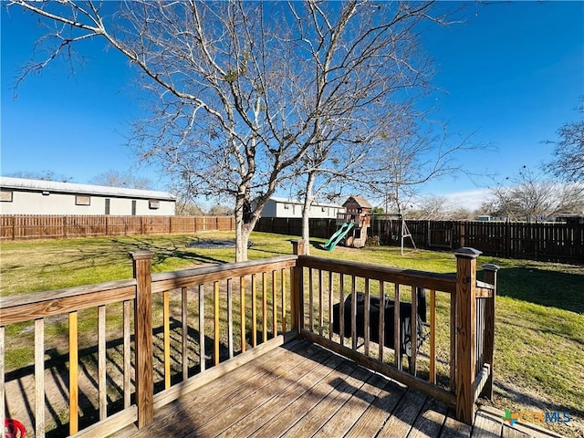 wooden deck with a playground and a lawn