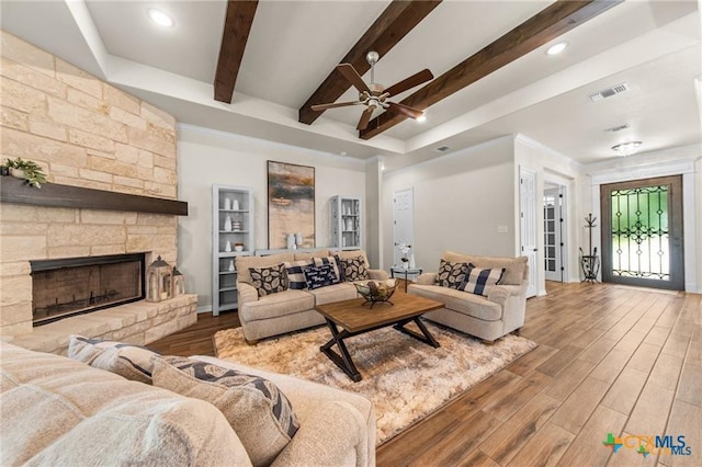 2755 Bowles Ranch Rd, Belton, TX 76513 - living room featuring wood finished floors, beamed ceiling, ceiling fan, recessed lighting, and a fireplace