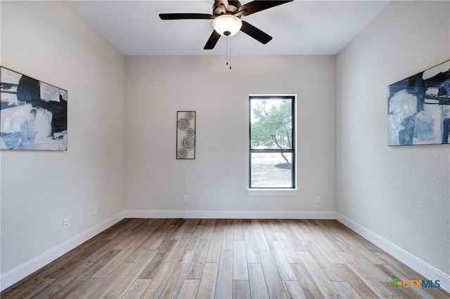 empty room featuring ceiling fan and light hardwood / wood-style flooring