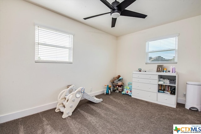 playroom featuring carpet flooring, ceiling fan, and a healthy amount of sunlight