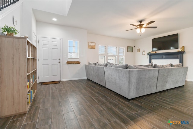 unfurnished living room with dark hardwood / wood-style floors and ceiling fan