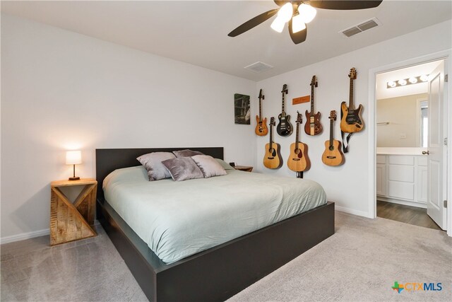 carpeted bedroom featuring ensuite bathroom and ceiling fan