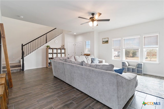 living room with dark wood-type flooring and ceiling fan