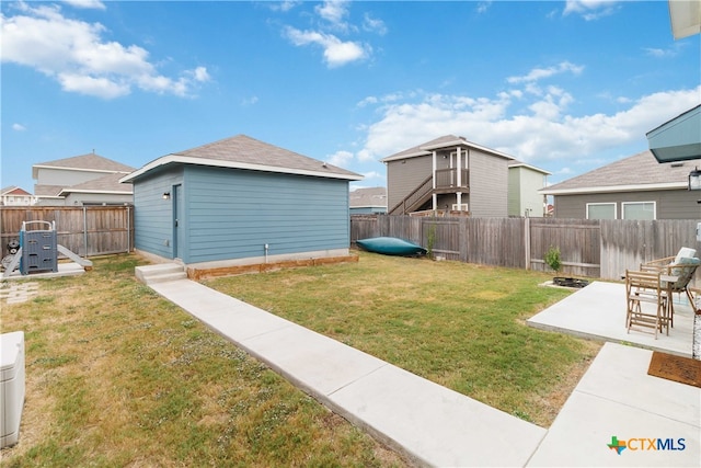 view of yard with an outbuilding and a patio