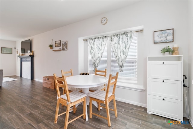 dining area with dark hardwood / wood-style flooring