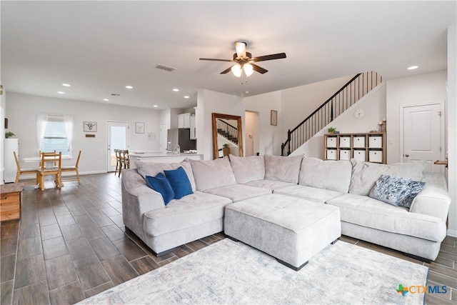 living room featuring dark hardwood / wood-style flooring and ceiling fan