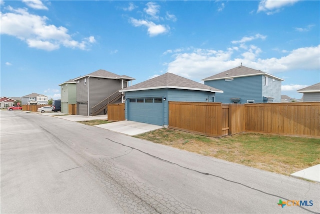 view of front of house featuring a garage and a front lawn