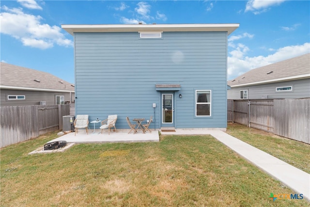 rear view of house featuring central AC, a yard, and a patio area