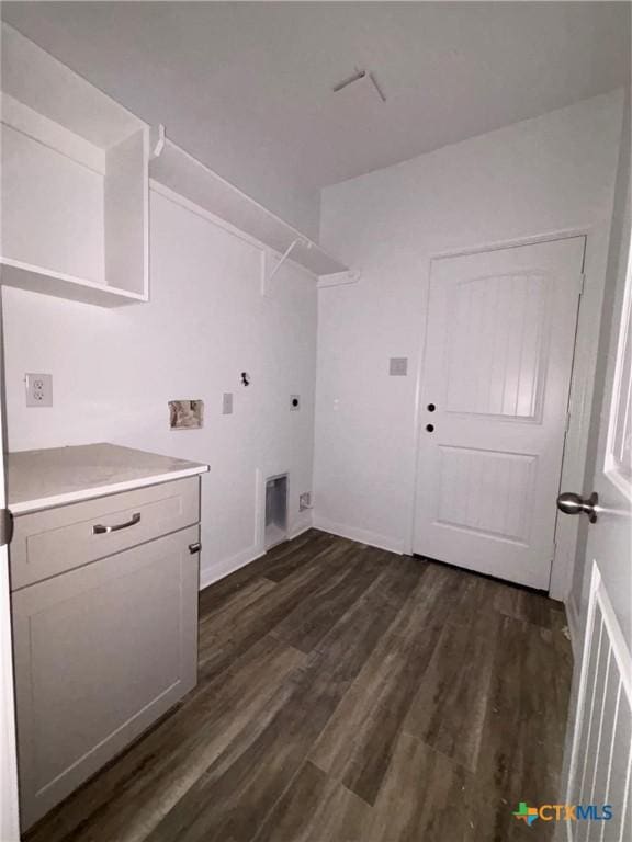 laundry area with cabinet space, baseboards, hookup for an electric dryer, and dark wood-type flooring