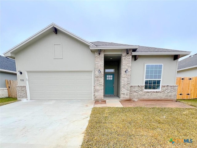 view of front facade featuring a garage and a front lawn