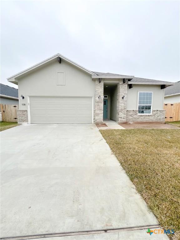 ranch-style house with a garage and a front yard