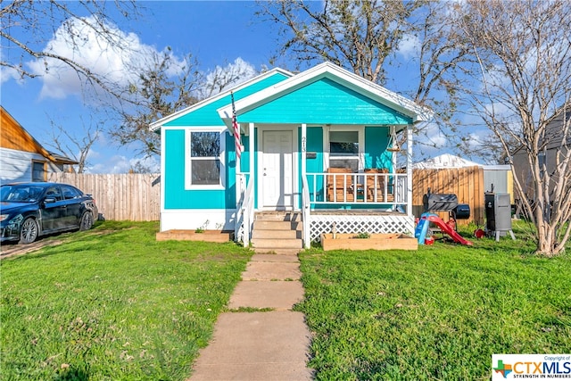 bungalow-style house featuring a front lawn and a porch