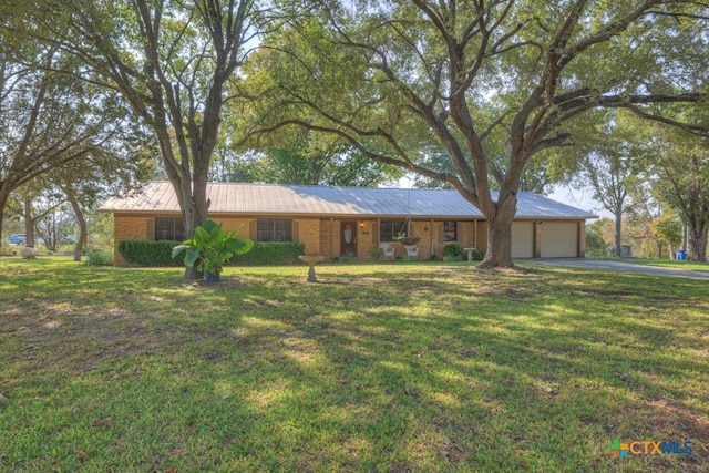 single story home with a garage and a front yard