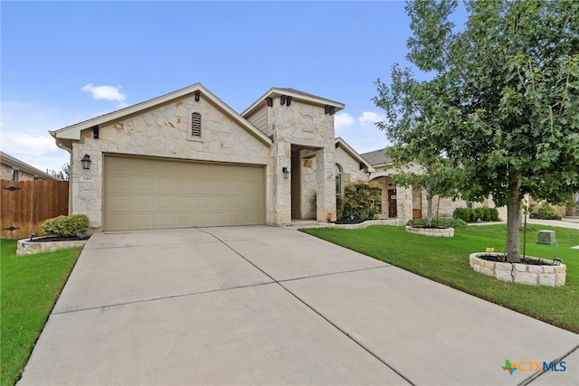 view of front of home featuring a front yard and a garage