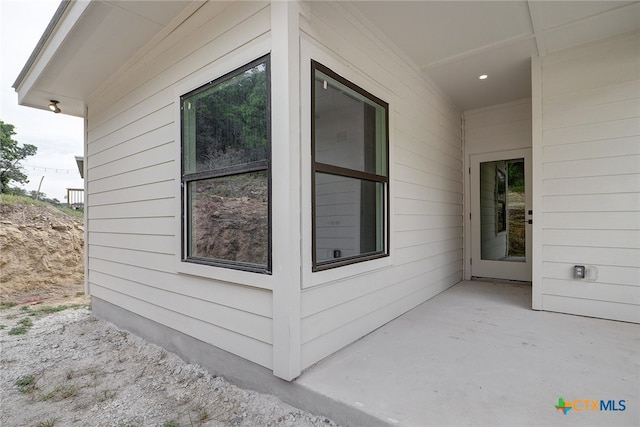 view of side of property with a patio area