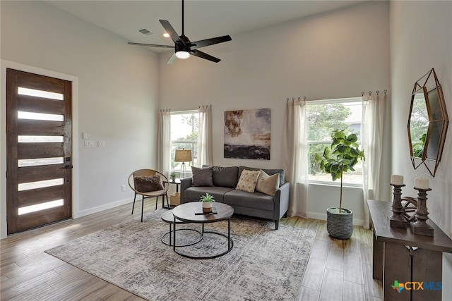 living room featuring high vaulted ceiling, ceiling fan, and light hardwood / wood-style floors