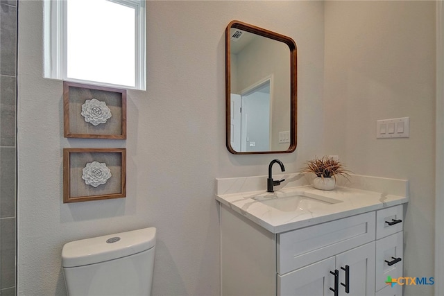 bathroom with vanity and toilet