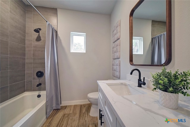 full bathroom featuring shower / tub combo with curtain, vanity, and toilet