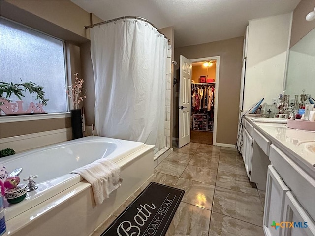 bathroom with vanity and independent shower and bath