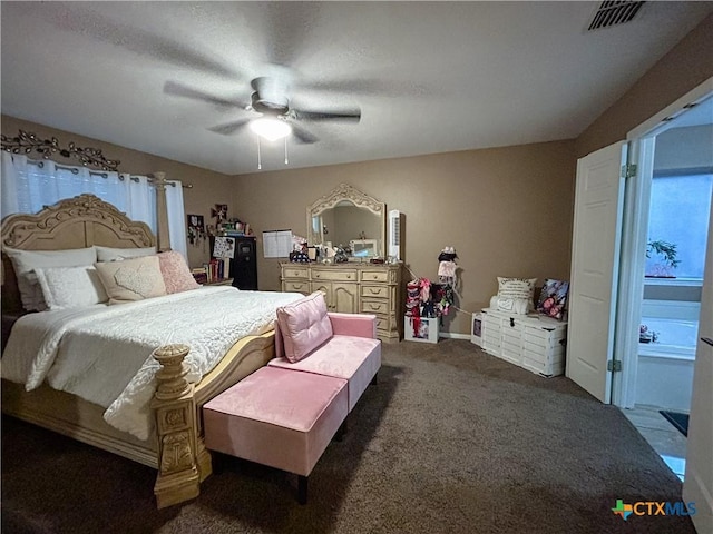 bedroom featuring ensuite bathroom, carpet, and ceiling fan