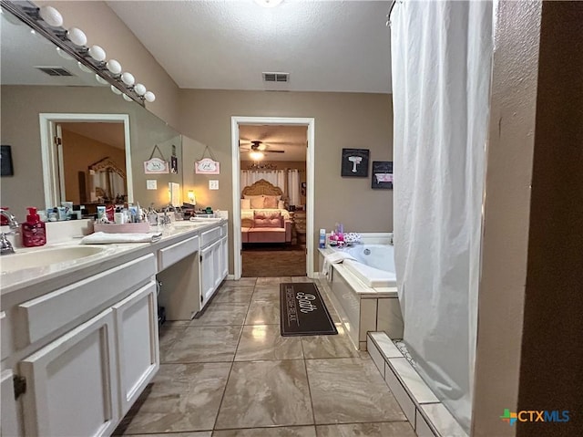 bathroom featuring vanity, ceiling fan, and a tub to relax in