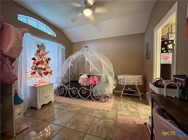 tiled bedroom featuring vaulted ceiling and ceiling fan