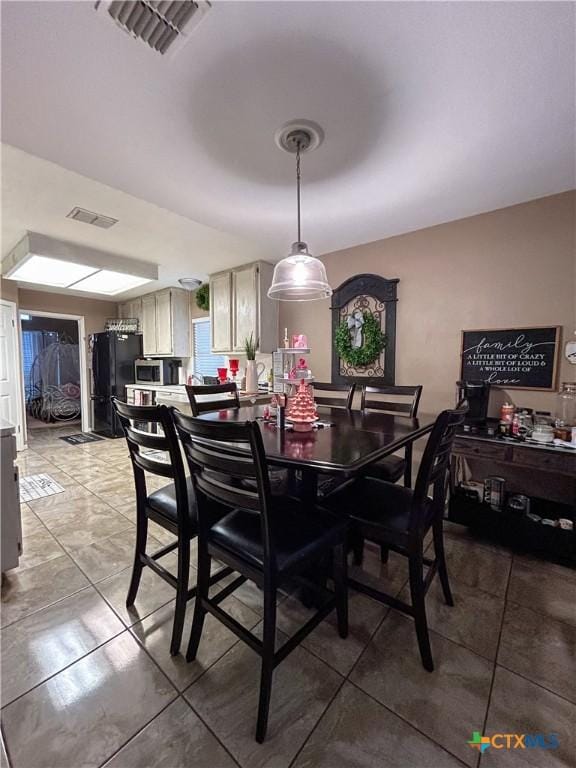 dining space with tile patterned flooring