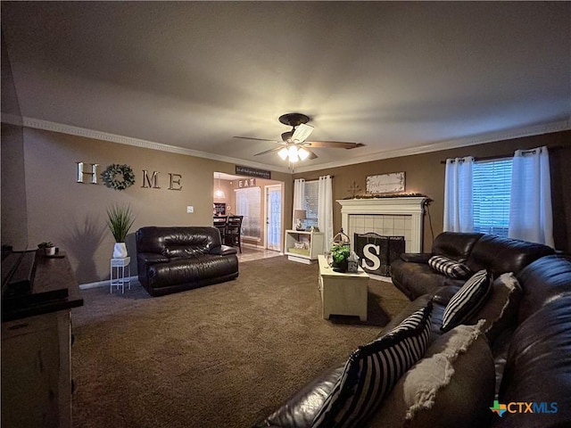 living room featuring crown molding, a fireplace, carpet flooring, and ceiling fan