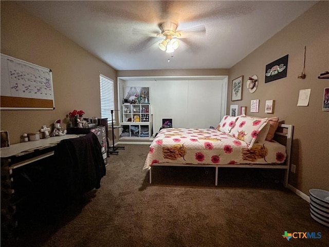 bedroom with ceiling fan, carpet flooring, and a textured ceiling